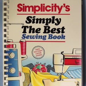 May include: A spiral-bound instructional sewing book titled Simplicity's Simply The Best Sewing Book. The cover features illustrations of sewing machines, a red pincushion, yellow fabric, and a measuring tape with the text Free Pattern Offer Inside.
