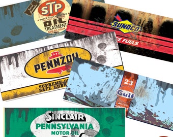 May include: A set of five vintage-style gas station signs with distressed paint and faded colors. The signs feature the logos for STP, Pennzoil, Sunoco, Gulf, and Sinclair Pennsylvania Motor Oil.