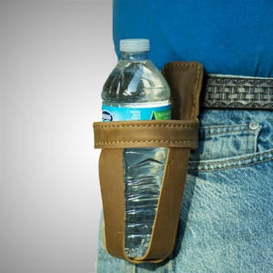 May include: A brown leather water bottle holder with a clear plastic water bottle inside. The holder is attached to a belt.