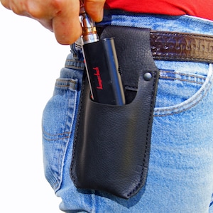 May include: A black leather holster with a red "Kangertech" logo, worn on a person's hip, holding a black and silver vape pen.