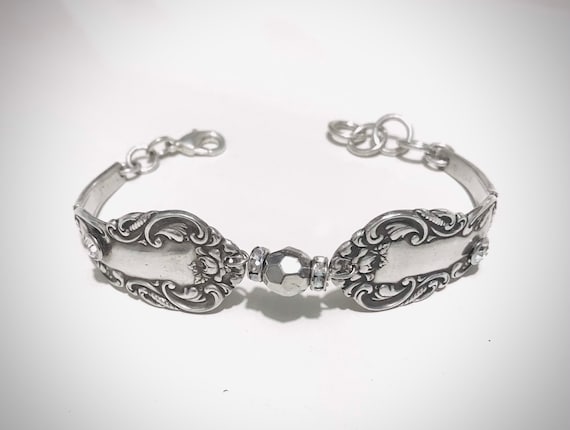 Vintage silverware bracelet with bling! Two diamond cz inlaid stones. Diamond circular beads at each side of silver bead in center.