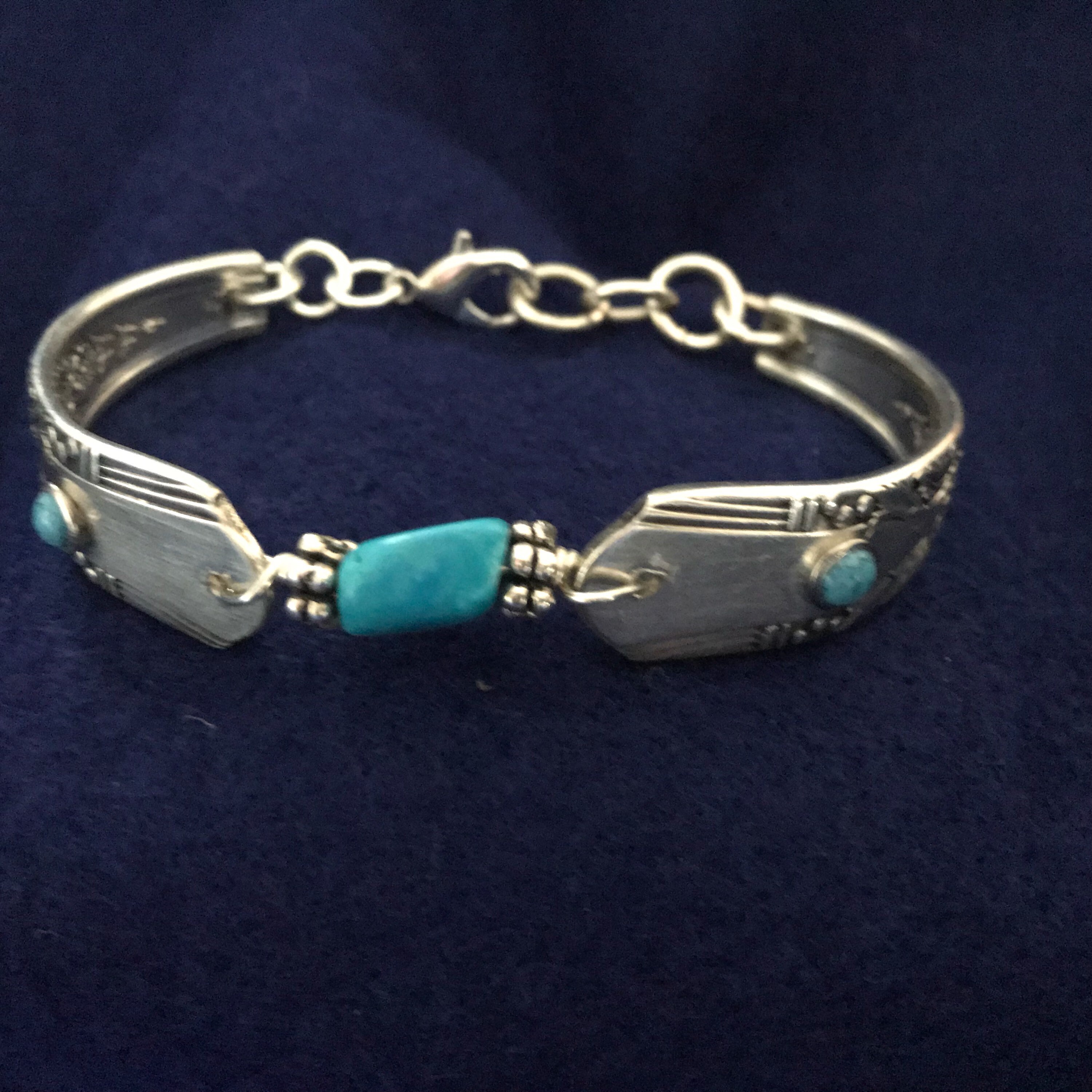 Vintage silverware bracelet with inlaid turquois beads. Adjustable size.
