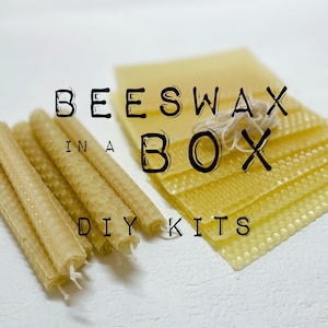 May include: Beeswax candle making kit with the text "Beeswax in a Box DIY Kits". The kit includes a stack of beeswax sheets and a bundle of honeycomb beeswax candles.