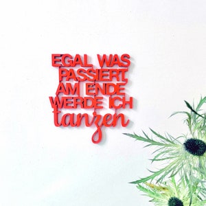 May include: Red wooden wall art with the German phrase "Egal was passiert am Ende werde ich tanzen" which translates to "No matter what happens, in the end I will dance".