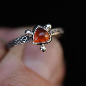 Red garnet ring with textured silver ringband, handcrafted with oxidized silver by silversmith, unique jewelry
