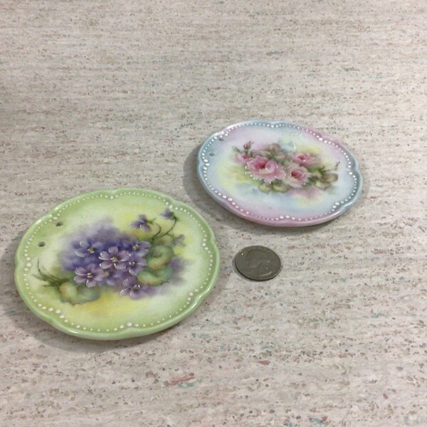 Two small hand painted china round plaques