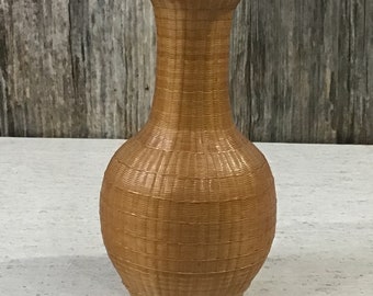 Finely woven Chinese rattan vase over ceramic