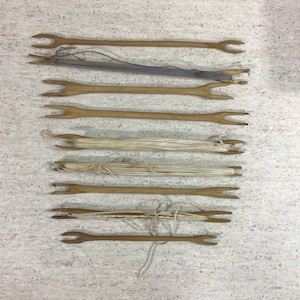 Lot of 9 antique had carved weaving stick shuttles