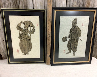 Pair framed gold embossed Asian inspired figures Doris M. Schrock