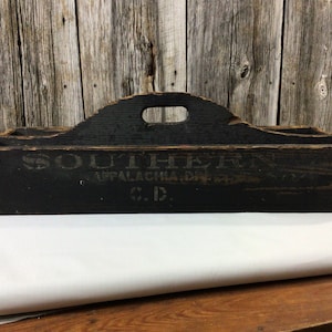 May include: A black wooden tool box with a handle. The box has the text "SOUTHERN APPALACHIA DIST. CO. C.D." printed on the front.