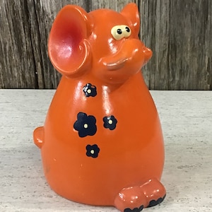 Retro bright orange cartoonish elephant bank