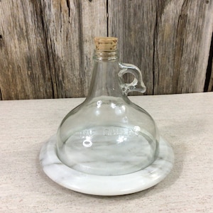 Vintage gallon jug cheese dome on marble base