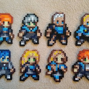 May include: Eight pixel art figures made of blue, white, and orange beads. The figures are all wearing blue and white outfits and have different hairstyles.