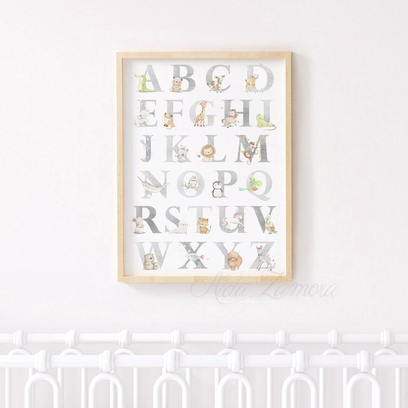 May include: A framed alphabet poster with a white background and gray letters. Each letter is decorated with a different animal illustration. The frame is light wood.