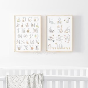 May include: Two framed prints with a white background. The left print features the alphabet with a gray letter and a small animal illustration next to each letter. The right print features the numbers 1-10 with a gray number and a small animal illustration next to each number.