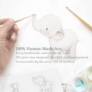 POV of artist Aida Zamora hand-painting a watercolor safari elephant decal. Authentic, 100% human-created nursery art without AI.