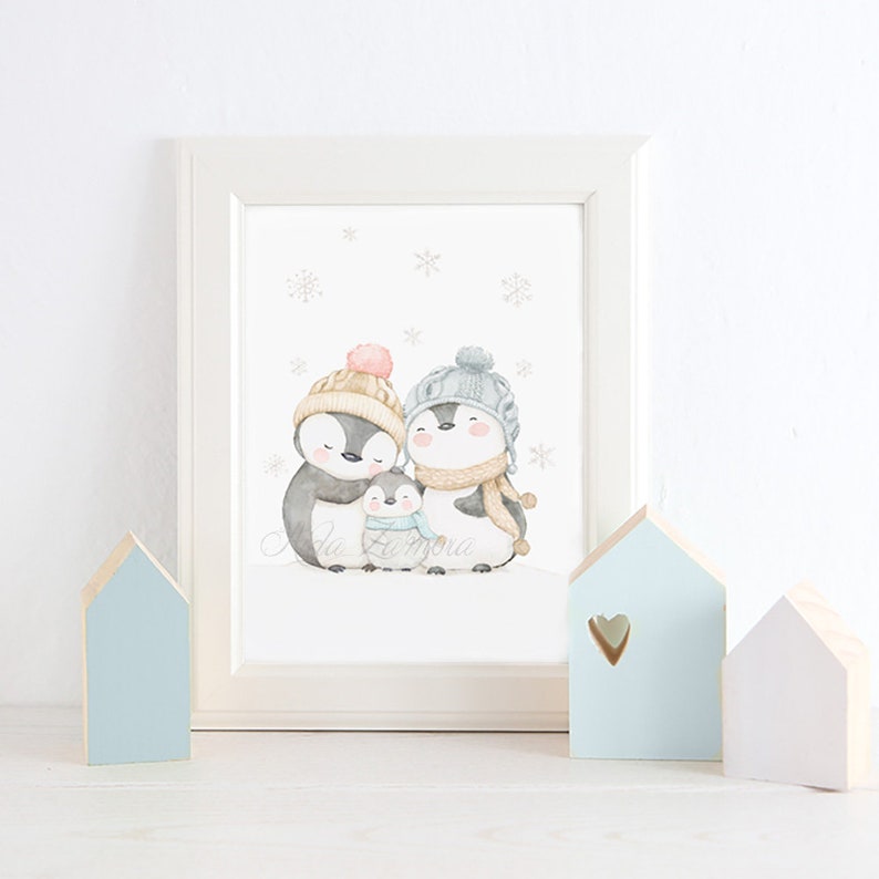 May include: A framed watercolour print featuring three penguins wearing winter hats and scarves, with a small penguin in the centre. The penguins are surrounded by light grey snowflakes on a white background, all encased in a white frame.