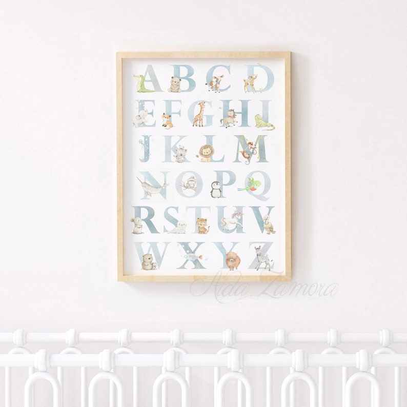 May include: A framed alphabet poster with a blue and white watercolor background. Each letter is paired with a different animal illustration. The letters are in a light blue font.