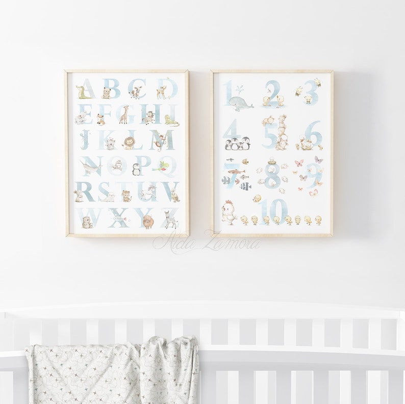 May include: Two framed prints with a blue and white background. The left print features the alphabet with animals for each letter. The right print features numbers 1-10 with animals for each number.