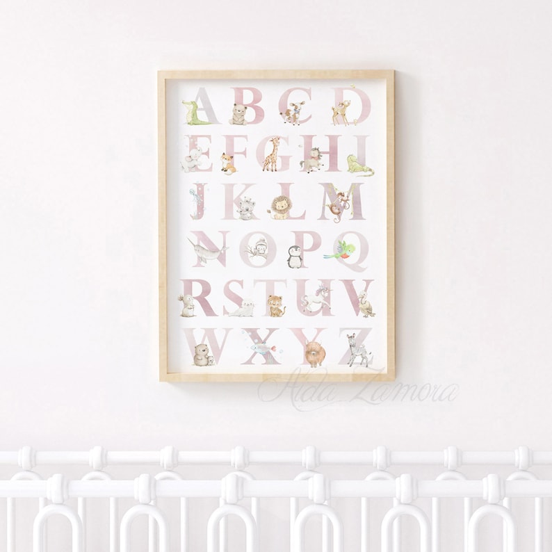May include: A pink and white alphabet poster with a different animal for each letter. The animals are illustrated in a watercolor style. The poster is framed in a light wood frame.