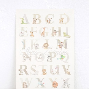 May include: A white and beige alphabet poster with animal illustrations for each letter. The letters are in a light brown font. The animals include a crocodile, bear, deer, fox, giraffe, horse, frog, koala, lion, monkey, narwhal, owl, penguin, parrot, rabbit, tiger, unicorn, sheep, bear, fish, yak, and zebra.