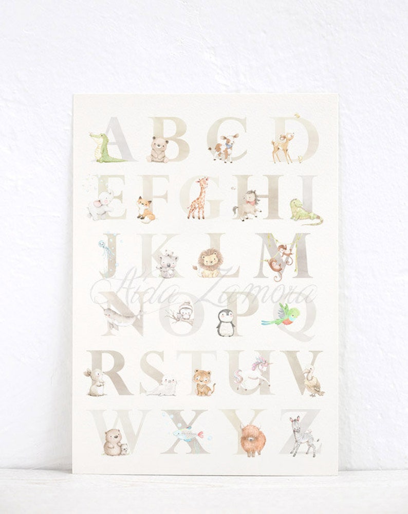 May include: A white and beige alphabet poster with animal illustrations for each letter. The letters are in a light brown font. The animals include a crocodile, bear, deer, fox, giraffe, horse, frog, koala, lion, monkey, narwhal, owl, penguin, parrot, rabbit, tiger, unicorn, sheep, bear, fish, yak, and zebra.