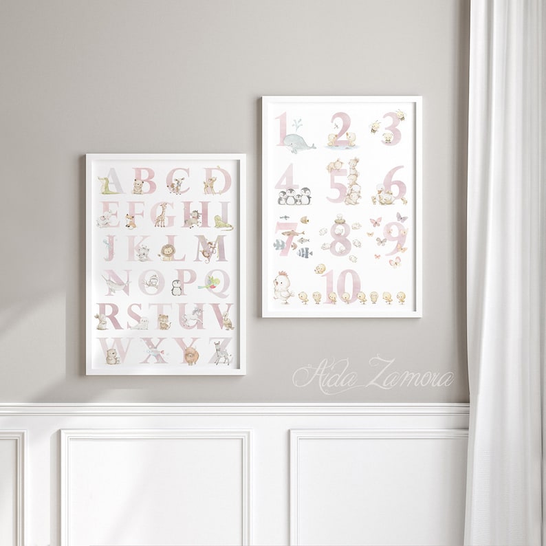 May include: Two framed prints with a pink and white color scheme. The first print features the alphabet with a different animal for each letter. The second print features the numbers 1 through 10 with a different animal for each number.