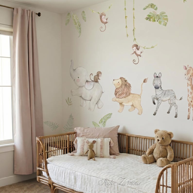 May include: A nursery with a jungle theme. The wall features watercolor illustrations of an elephant, lion, zebra, and giraffe. A rattan bed is in the foreground, with a teddy bear and decorative pillows. The bed has a white textured cover.
