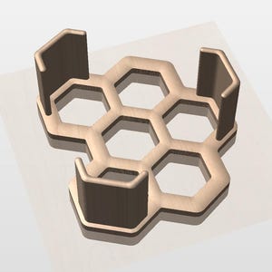 May include: A light brown, honeycomb-shaped object with three vertical supports. The design features six hexagonal openings and three upright, rectangular supports. The object is likely a decorative or functional item, possibly a coaster or a small display stand.