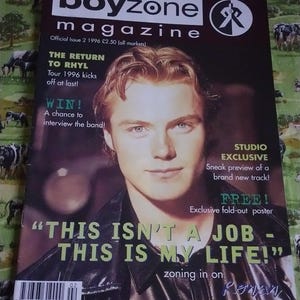 May include: A Boyzone magazine cover with a man on the front. The magazine is titled "boyzone magazine" and includes the text "THIS ISN'T A JOB - THIS IS MY LIFE!". The background is a cow-print fabric.