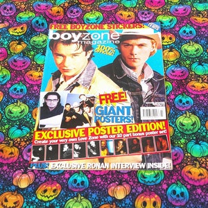 May include: A Boyzone magazine with two men on the cover, with the text "FREE BOYZONE STICKERS" and "FREE GIANT POSTERS!" The magazine is on a colourful fabric with jack-o'-lanterns.