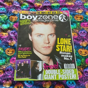 May include: A Boyzone magazine featuring Ronan on the cover, with the headline "Lone Star!". The magazine also advertises a "Double-Sided Giant Poster!". The background is a fabric with a repeating pumpkin pattern.