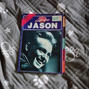 May include: A vintage magazine titled "Star Showcase" featuring a black and white image of a smiling man named Jason. The cover has a blue border with the text "Collectors Pack" and "Free Plus" on the top.