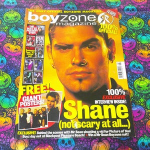 May include: A magazine cover for Boyzone, featuring a man with a nose ring. The magazine has the text "boyzone magazine" and "100% OFFICIAL!". The cover also includes the text "Shane (not scary at all...)" and "FREE! GIANT POSTERS!"