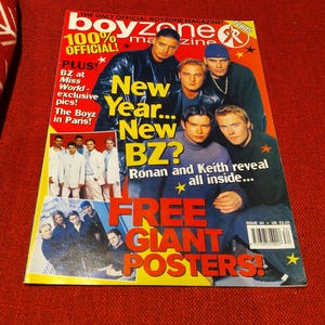 May include: A magazine cover for Boyzone, featuring the band members. The cover is predominantly yellow and red, with text including "New Year... New BZ?" and "Free Giant Posters!" and the magazine title.