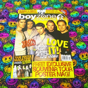 May include: A magazine cover for Boyzone, featuring five men. The cover has the text "LOVE IT!" in yellow, along with "100% OFFICIAL!" and "FREE! EXCLUSIVE SOUVENIR TOUR POSTER MAG!" The background is a colorful pattern of pumpkins.
