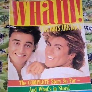 May include: A retro magazine cover for Wham!, with the band's name in bold red letters. The cover features images of the band members and text that reads "The COMPLETE Story So Far - And What's in Store!" and "PIX - FAX - NEWS 'n GOSSIP".