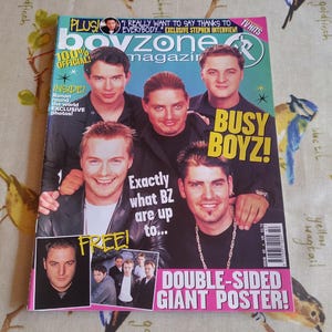 May include: A Boyzone magazine featuring a group of men. The magazine cover has the text "Boyzone magazine" and "Busy Boyz!" with the text "Double-sided giant poster!" also visible.