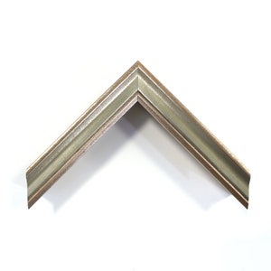 May include: A silver picture frame with a slightly raised edge and a subtle distressed finish.