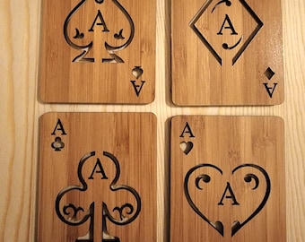 May include: Four wooden coasters featuring the Ace of Spades, Ace of Diamonds, Ace of Clubs, and Ace of Hearts. Each coaster has a unique design with the suit symbol and the letter 'A' in the center.