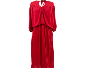 May include: A red midi dress with long sleeves and a keyhole neckline. The dress features a gathered bodice, an elastic waist, and a flowing skirt. The sleeves have a slight puff at the shoulder and gather at the wrist. The dress is made of a soft, flowing fabric.