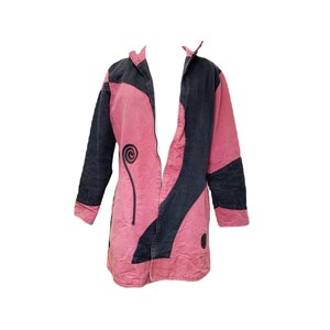 May include: A pink and black long-sleeved jacket with a swirl design on the front.