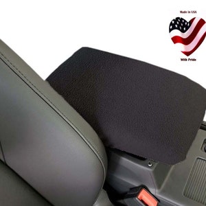 May include: Black fleece car seat armrest cover. Made in the USA with pride.