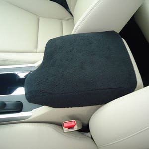 May include: Black fleece car center console armrest cover. The cover is installed on a beige leather car seat.