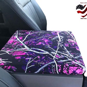 May include: Pink and black camouflage car seat cover. The cover is made of a soft, durable fabric and features a pink and black camouflage pattern. It is designed to protect your car seat from dirt, spills, and wear and tear.