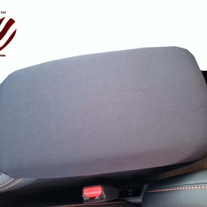 May include: Black car seat armrest cover. The cover is made of a soft, durable fabric and is designed to protect your armrest from wear and tear. It is easy to install and remove, and it can be machine washed.
