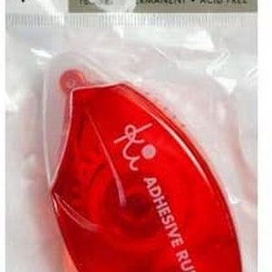 May include: A red adhesive runner in a clear plastic package. The dispenser is teardrop-shaped with the words "ADHESIVE RUNNER" printed on it. The package also includes the text "DOUBLE SIDED ADHESIVE DISPENSER PERMANENT ACID FREE".