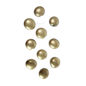 May include: Ten gold-colored round buttons, scattered on a white background.