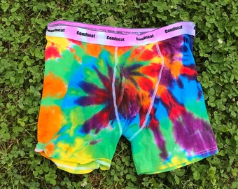 May include: Tie-dye boxer shorts with a rainbow pattern and the word "Comfneat" repeated on the waistband.