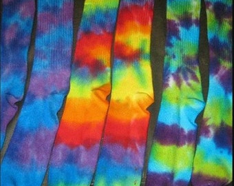 May include: Six pairs of colorful tie-dye socks in a variety of colors, including blue, green, purple, orange, and yellow.